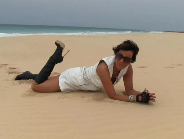 Nanalou in white leather dress at the beach in Cabo Verde